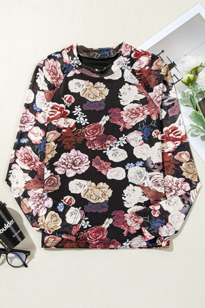 Black mesh blouse with a romantic floral print and long sleeves.
