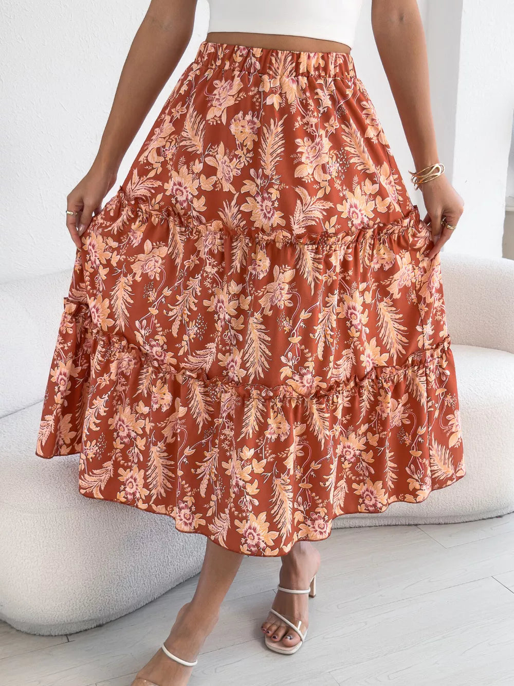 Romantic floral midi skirt in orange with ruffle tiers and hem.