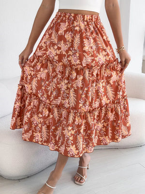 Romantic floral midi skirt in orange with ruffle tiers and hem.
