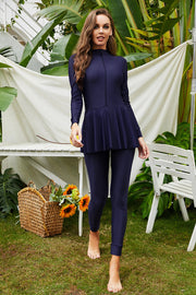 Dark Blue long sleeve swimsuit with flounce hem and leggings.