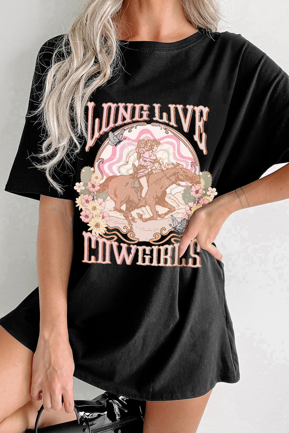 Black graphic tee with a cowgirl riding a horse and floral design, featuring text "LONG LIVE COWGIRLS".