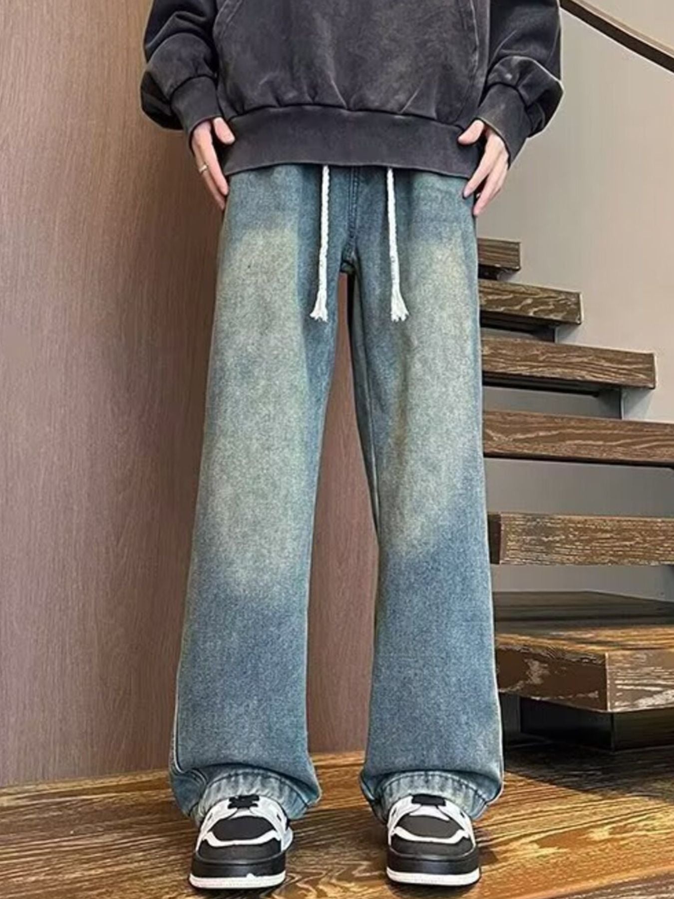 Men's blue wide leg jeans with drawstring waist and faded wash