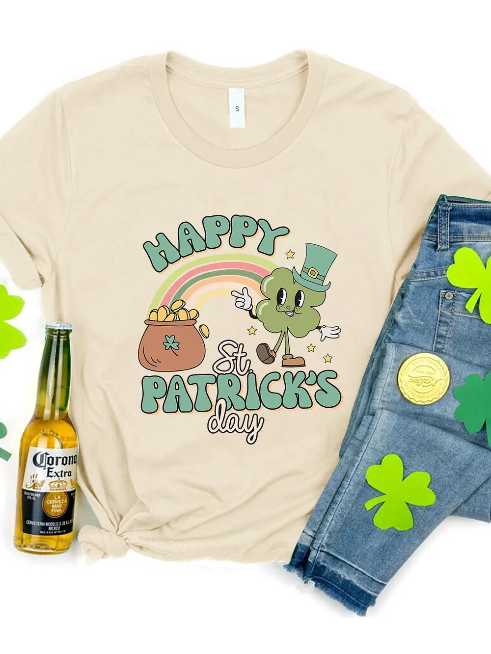 Cream t-shirt with Happy St. Patrick's Day graphic featuring a clover character and rainbow.