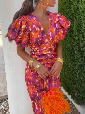 Vibrant abstract print midi dress with V-neck, puff sleeves, and ruched waist.