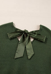 Dark green ribbed knit sweater with a satin bow detail at the back neckline.