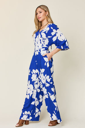 Cobalt floral kimono jumpsuit with wide legs and v-neckline.