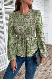 Green damask print peplum blouse with smocked bodice and puff sleeves.