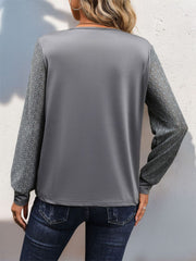 Dark gray blouse with lace inset long sleeves and a crew neck.