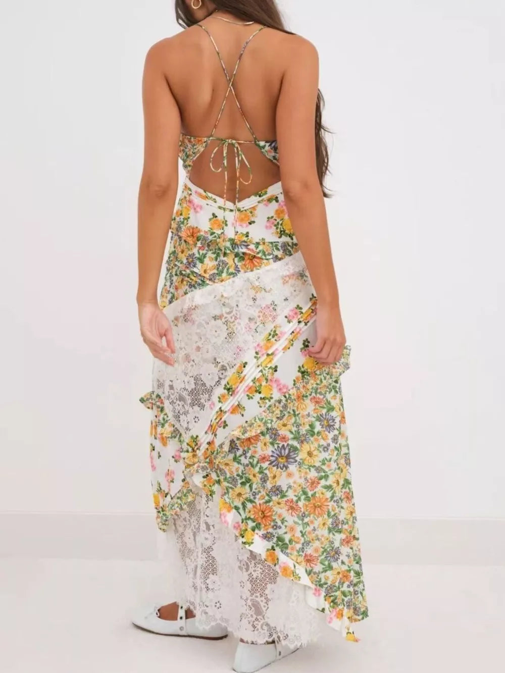 Maxi dress with floral print, lace trim, and crisscross back detail.