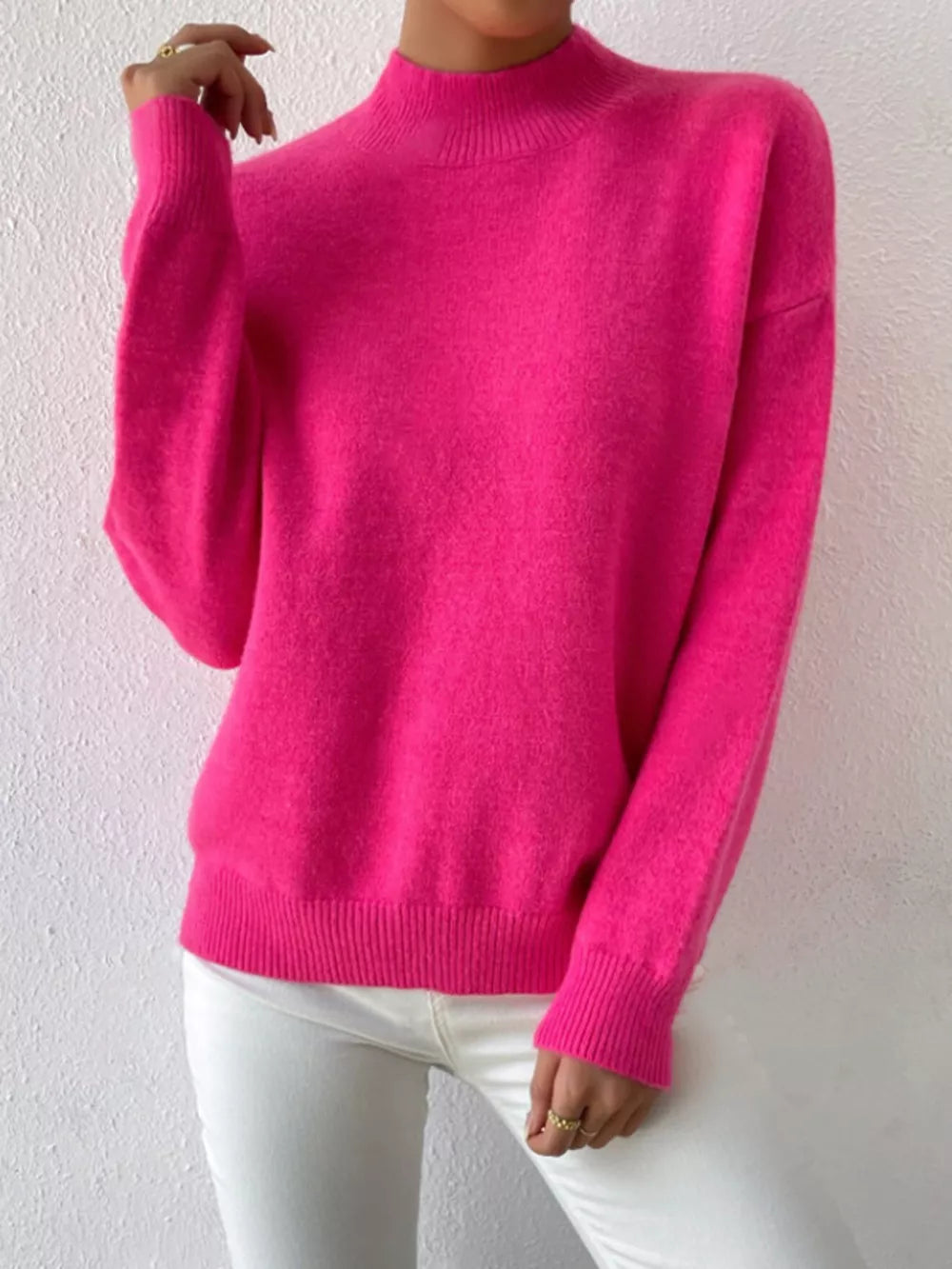Fuchsia pink acrylic mock neck sweater with dropped shoulders and ribbed cuffs and hem.