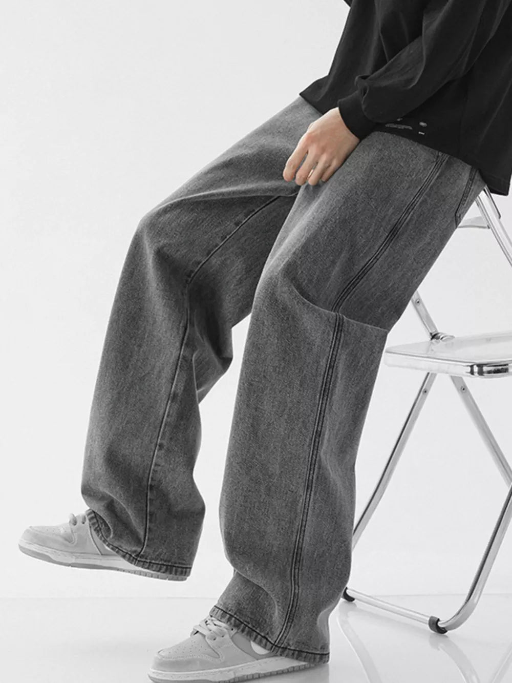 Relaxed wide-leg jeans in dark gray denim with drawstring waist and casual styling.