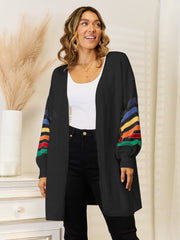 Black open-front knit cardigan with rainbow striped sleeves