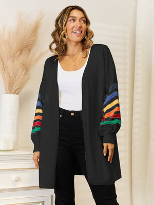 Black open-front knit cardigan with rainbow striped sleeves