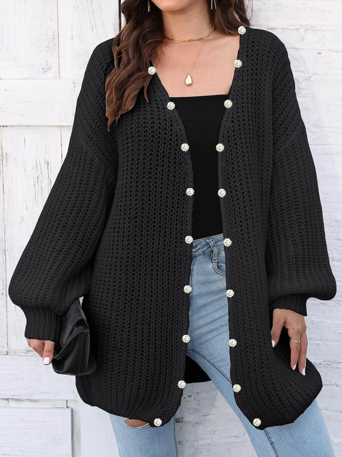 Black balloon sleeve cardigan with pearl buttons and open front.