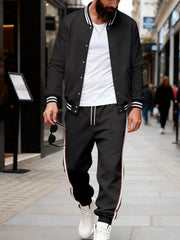 Men's black track pants with white and red side stripes and drawstring waist.
