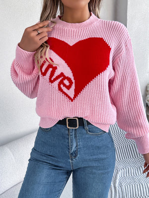 Pink knit sweater with a red heart and "love" graphic, crew neck, long sleeves.