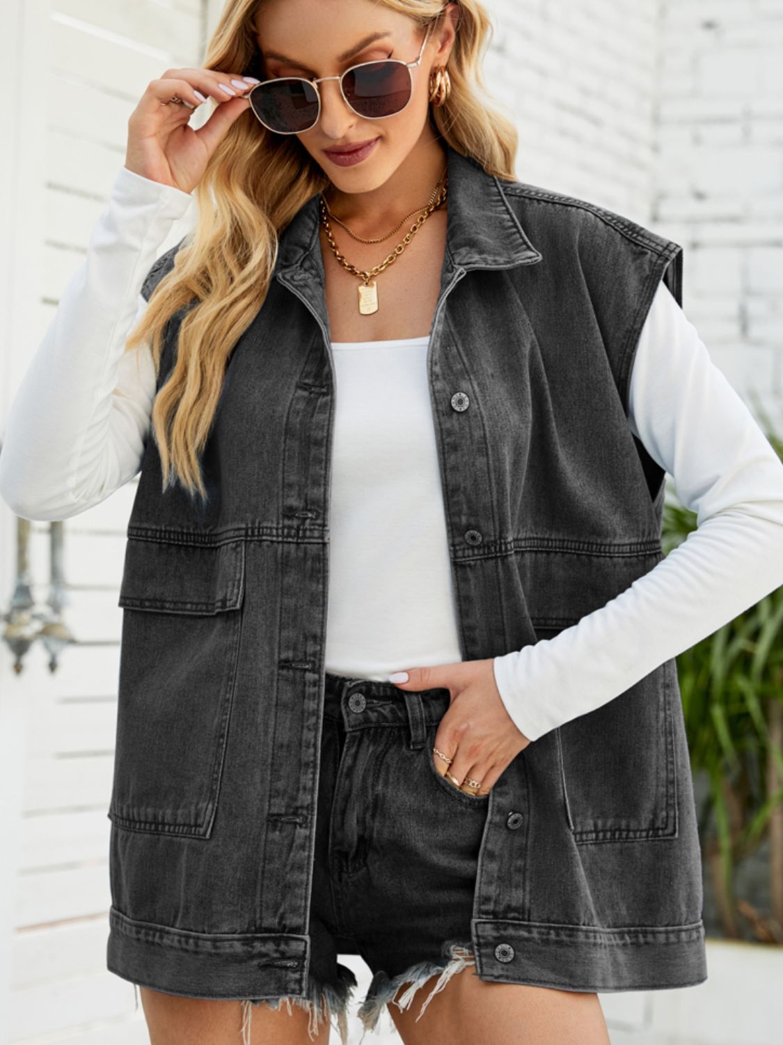 Dark denim utility vest with oversized pockets and collared neckline.