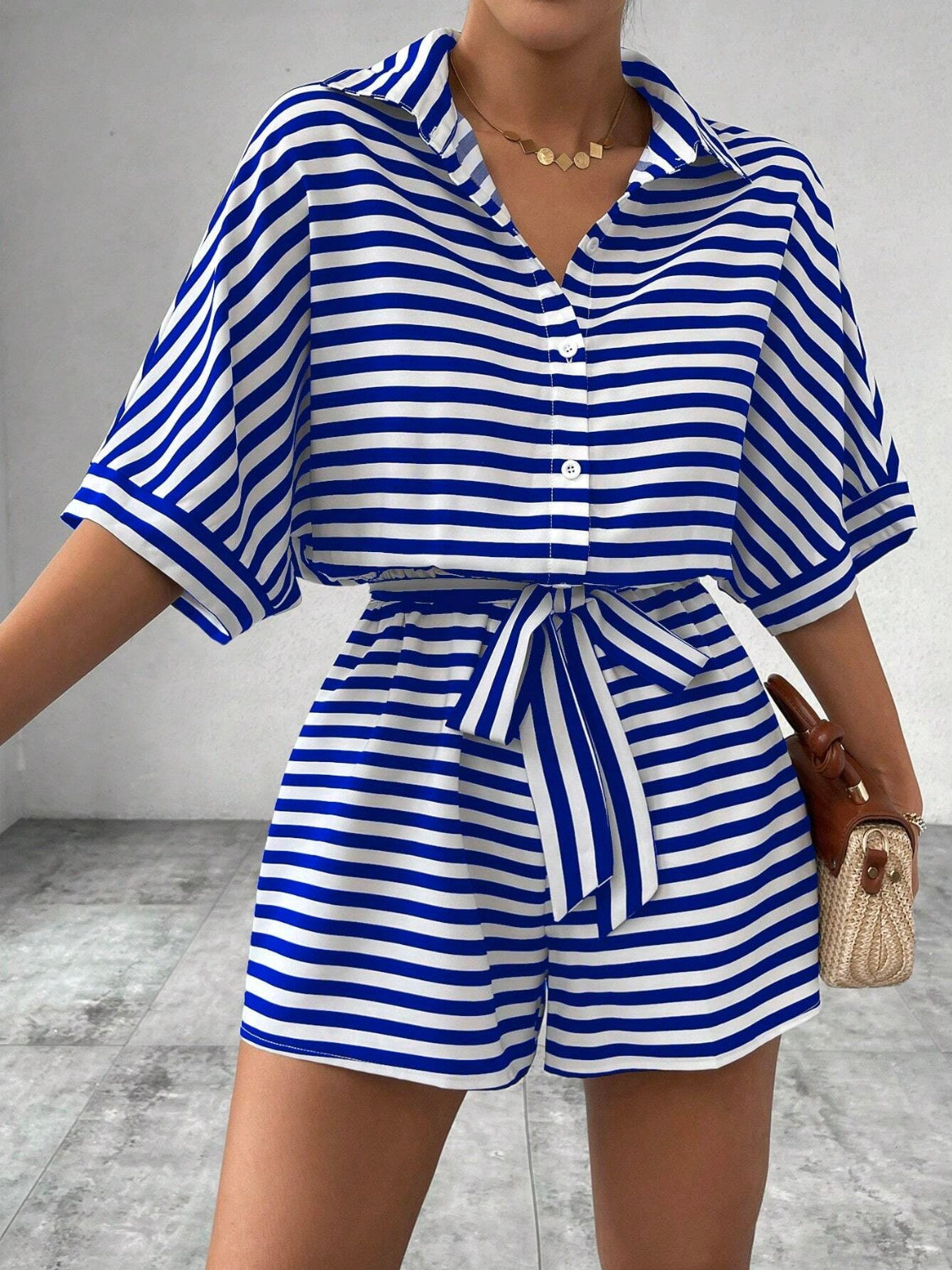 Royal blue and white striped shirt romper with self-tie belt and button front.