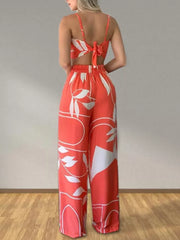 Orange tropical print crop top and wide-leg pants set with tie-back detail.