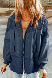 Colorblock knit zip-up hoodie in Peacock Blue with waffle texture panels and a drawstring hood.