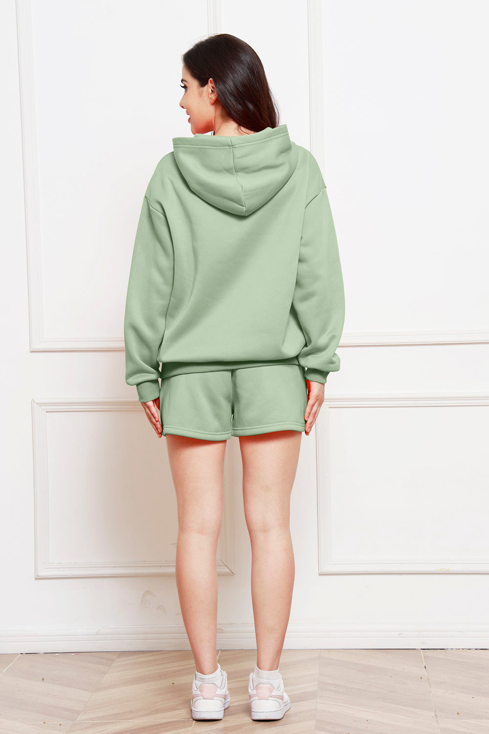 Sage oversized hoodie and bermuda shorts set from behind, casual loungewear