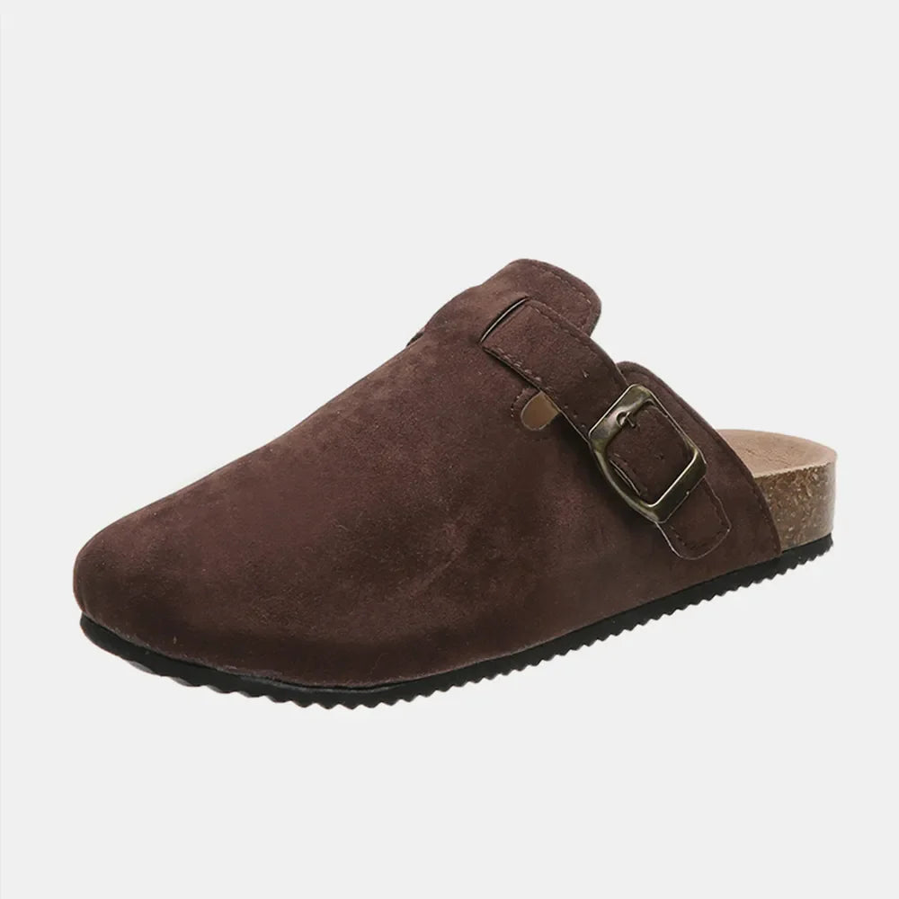 Chocolate suede clog slides with adjustable buckle and cork sole.