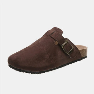 Chocolate suede clog slides with adjustable buckle and cork sole.