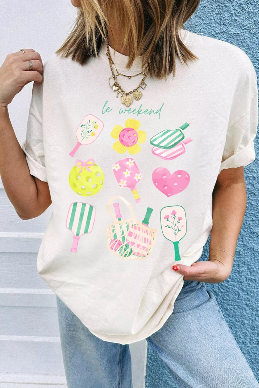 Cream polyester t-shirt with playful pickleball graphic and text.