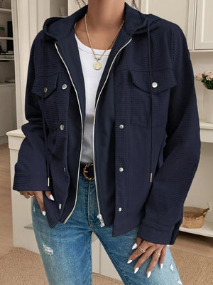 Dark navy waffle knit hooded jacket with buttoned pockets and drawstring hood.