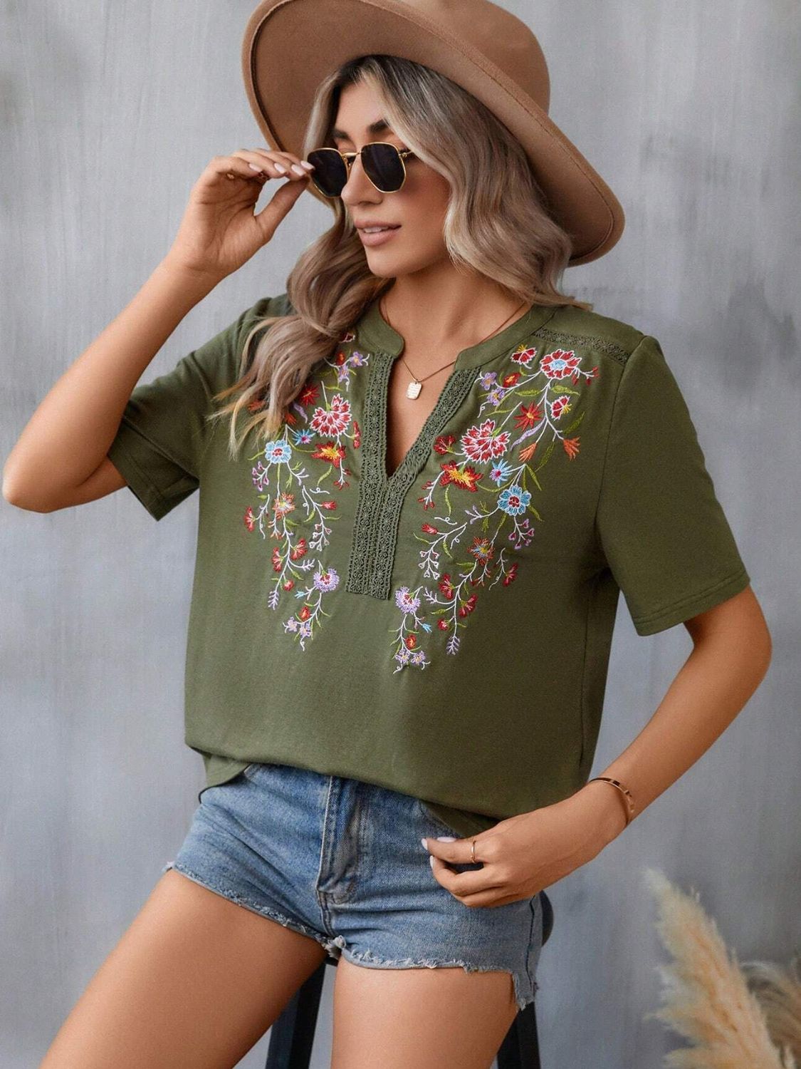Army green v-neck tee with colorful floral embroidery and crochet trim detail