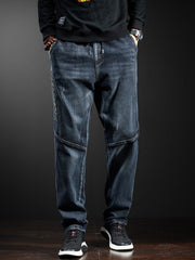 Men's dark wash distressed loose fit drawstring jeans with side text detail