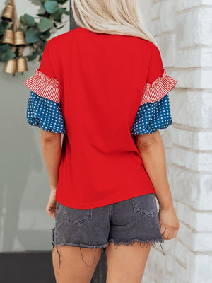 Maternity t-shirt with red ruffled sleeves, blue star print, and red stripe details.
