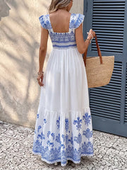 Printed square neck maxi dress with blue and white bohemian pattern and tiered skirt.