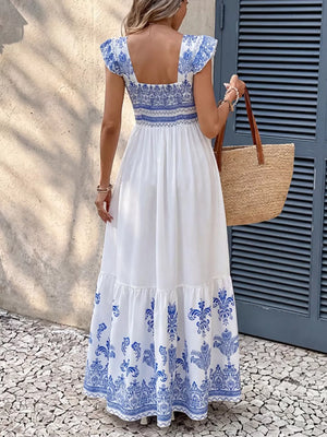 Printed square neck maxi dress with blue and white bohemian pattern and tiered skirt.