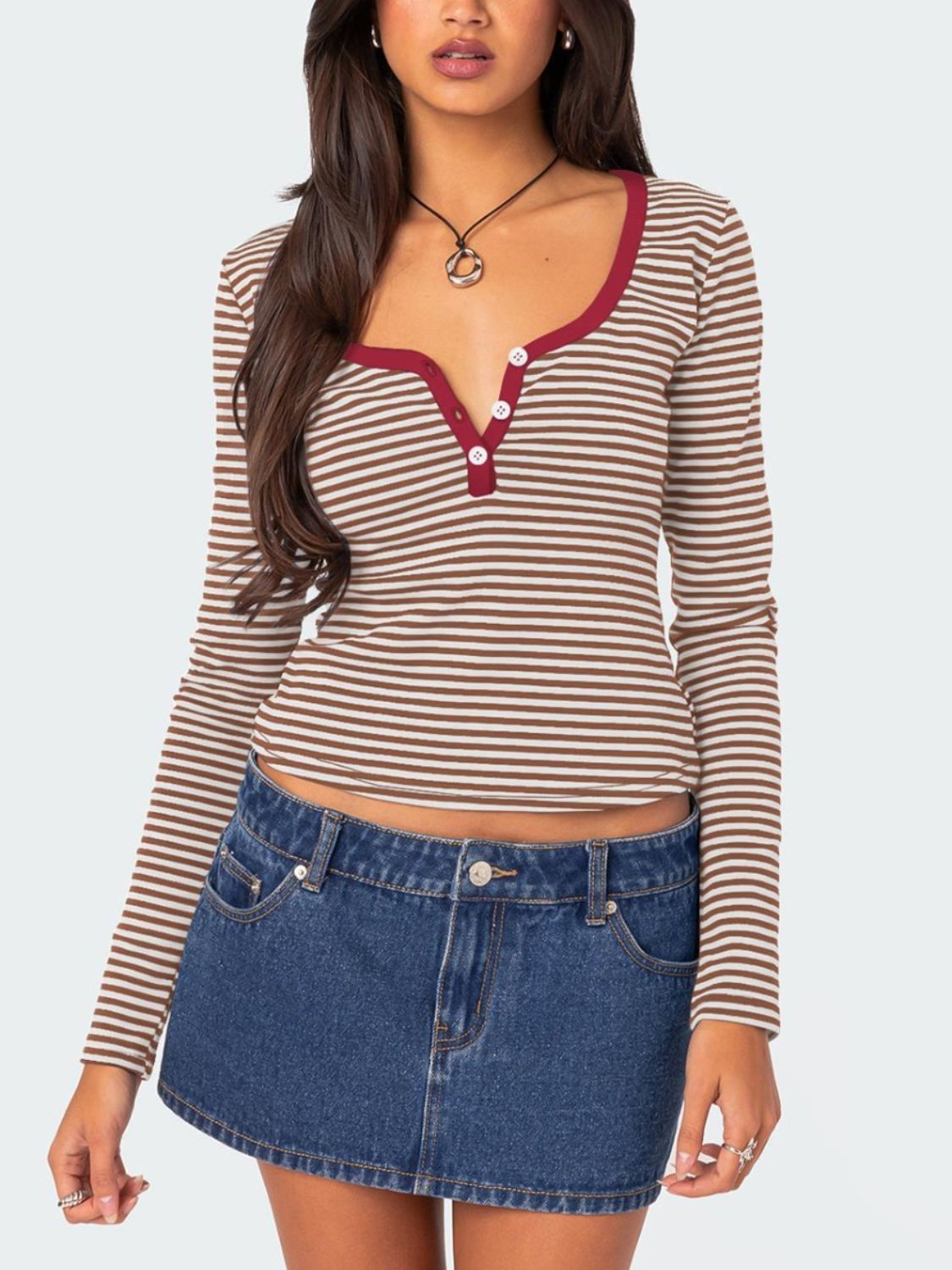 Striped long sleeve henley shirt with contrast collar and buttons.