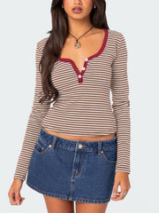 Striped long sleeve henley shirt with contrast collar and buttons.