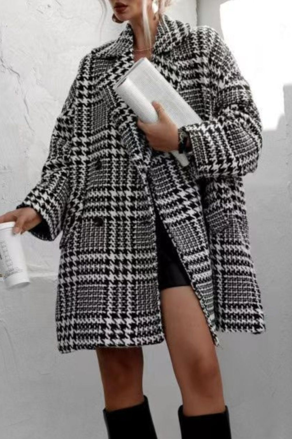 Oversized houndstooth cocoon coat in black and white with a double-breasted closure.