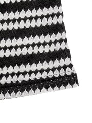 Black and white striped knit maxi dress with a textured pattern.