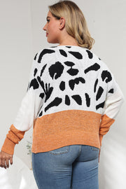 Dalmatian print colorblock knit sweater with orange band and white sleeves.