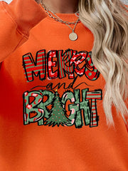 Orange crewneck sweatshirt with Merry and Bright graphic and Christmas tree detail
