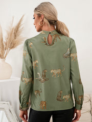 Matcha green leopard print blouse with keyhole neck detail and puff sleeves.