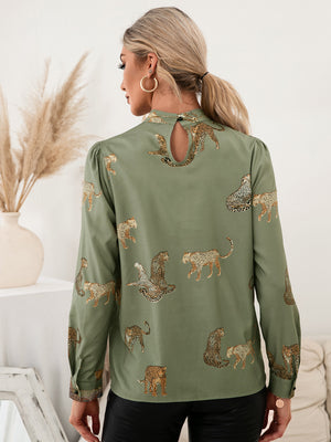 Matcha green leopard print blouse with keyhole neck detail and puff sleeves.