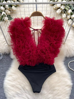 Wine red ruffled V-neck bodysuit with lace detail and tie back