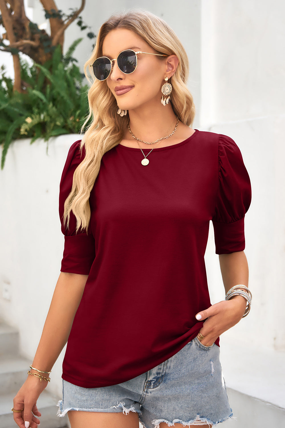 Burgundy crew neck top with puffed short sleeves and cuff detail
