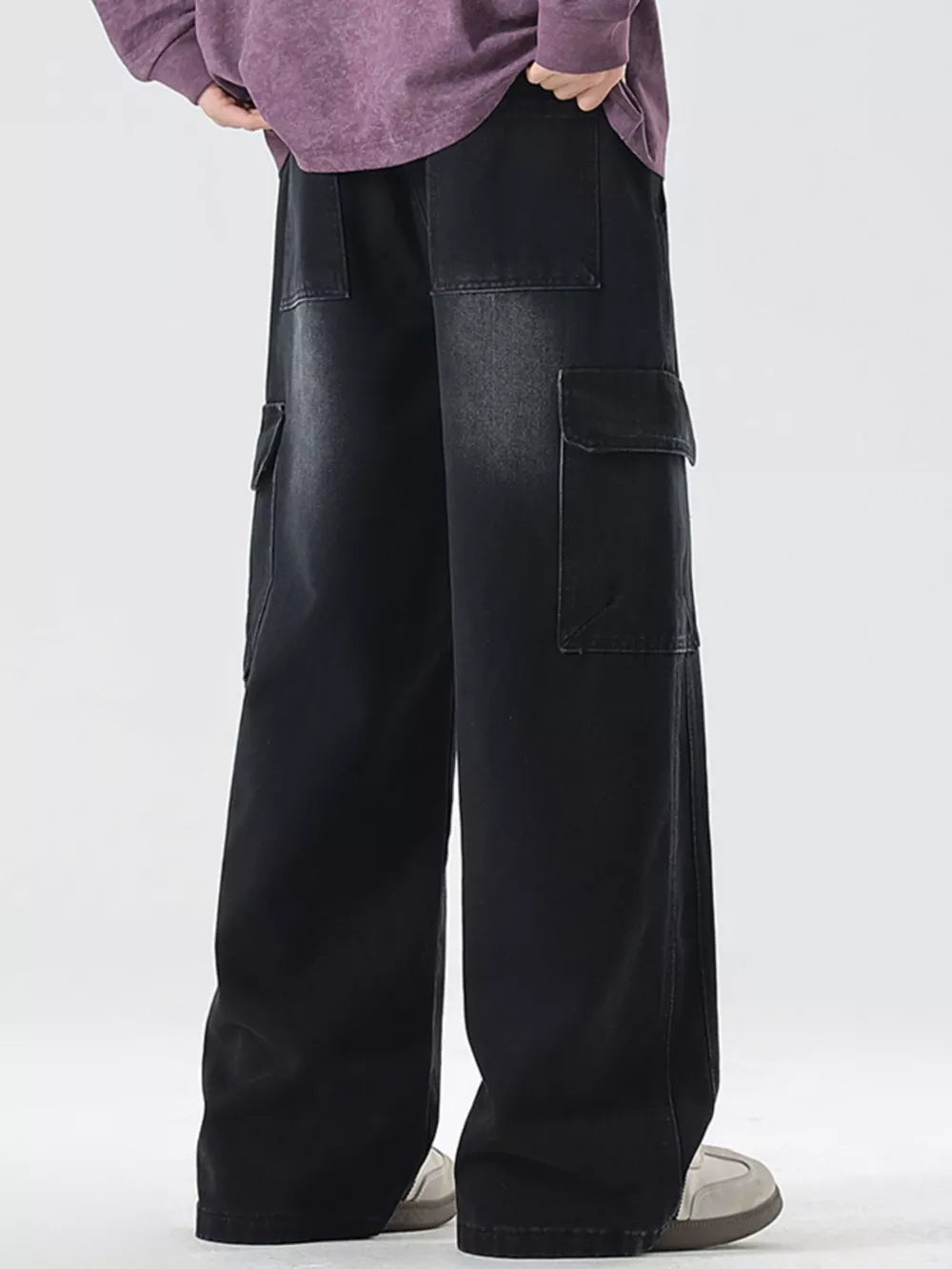 Black oversized cargo jeans with drawstring waist and large side pockets.