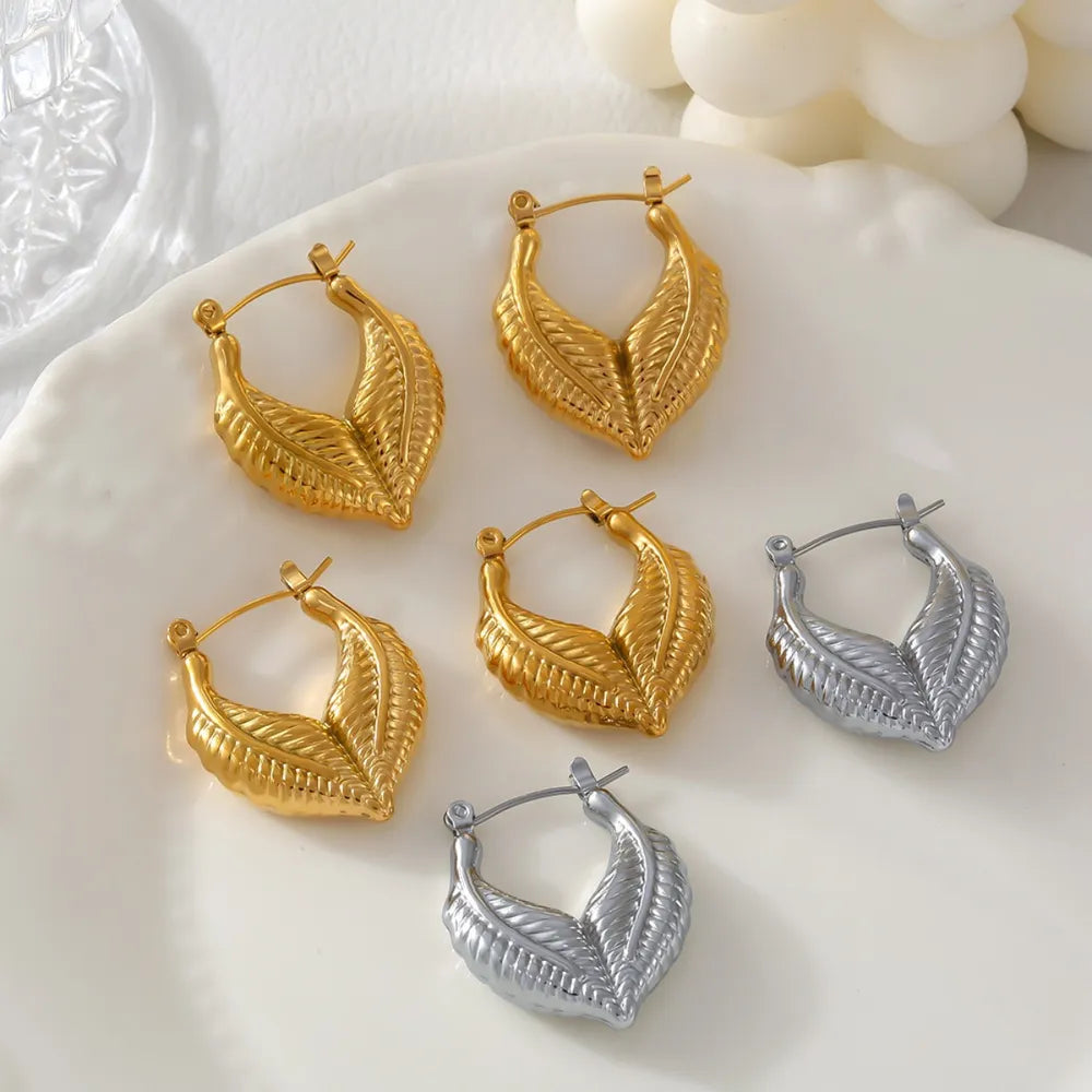 Textured gold leaf hoop earrings in gold and silver, 18K gold-plated.
