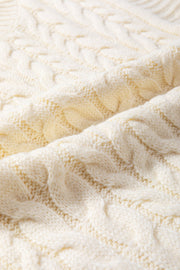 Ivory cable knit mock neck vest with chunky texture.