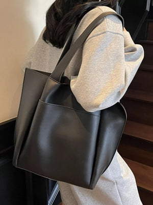 Black pu leather tote bag with exterior pocket and shoulder strap