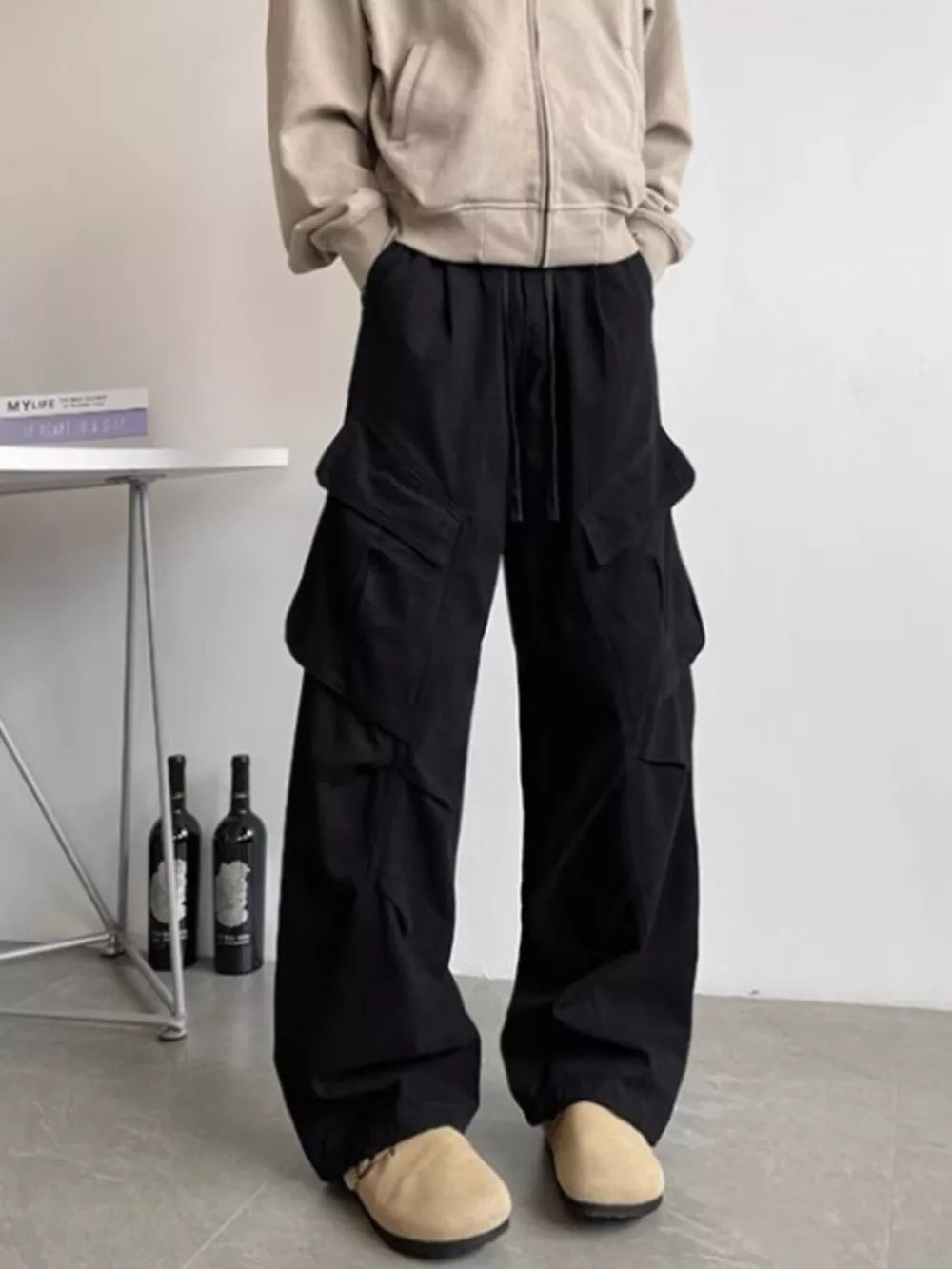 Black relaxed fit cargo pants with drawstring and multi pockets.