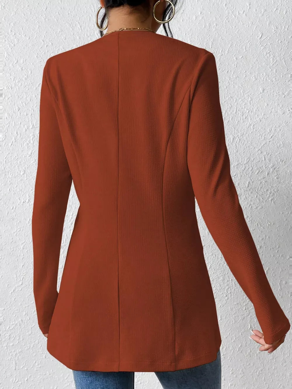 Brown single-button blazer with tailored fit and textured fabric.
